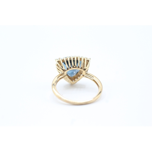 73 - 9ct gold diamond and blue gemstone halo ring (3.8g) Size O