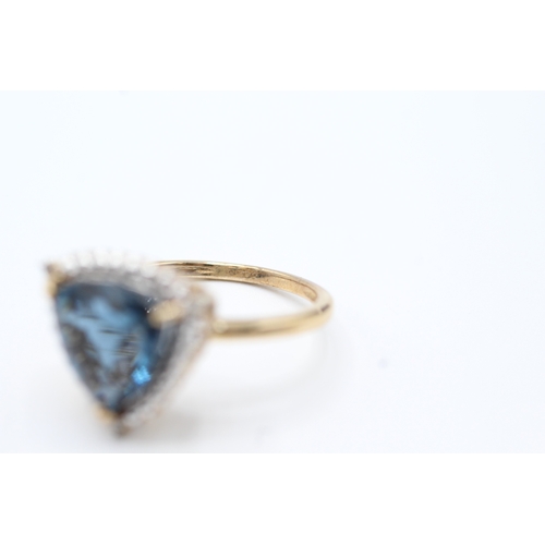 73 - 9ct gold diamond and blue gemstone halo ring (3.8g) Size O