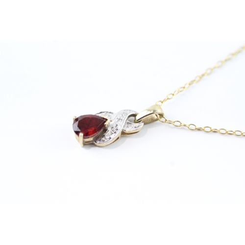 96 - 9ct gold single garnet & diamond by pass pendant necklace (2.8g)