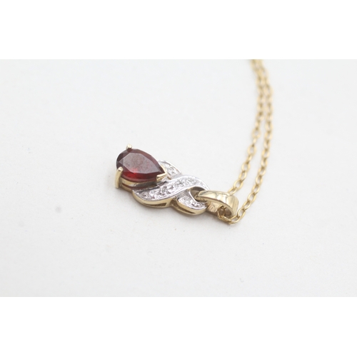 96 - 9ct gold single garnet & diamond by pass pendant necklace (2.8g)