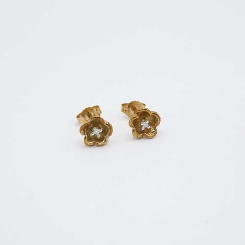 87 - 9ct gold diamond set floral stud earrings (1.6g)