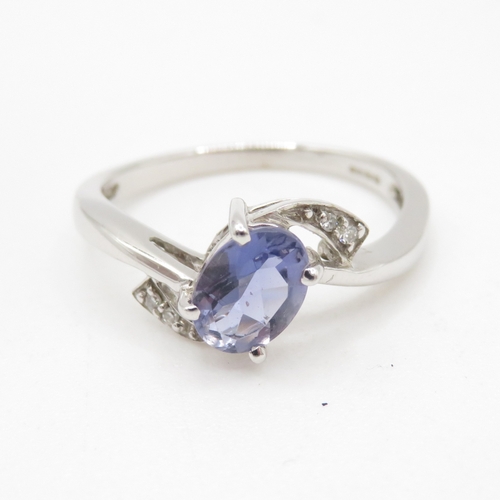 184 - 9ct white gold tanzanite and diamond crossover ring (2.4g) Size N