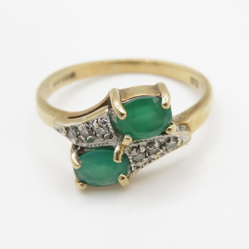 215 - 9ct gold emerald and diamond twin stone bypass ring (2.4g) Size J