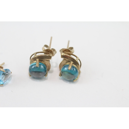 266 - 2 x 9ct gold blue topaz and blue gemstone stud earrings (3.8g)