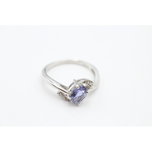 184 - 9ct white gold tanzanite and diamond crossover ring (2.4g) Size N