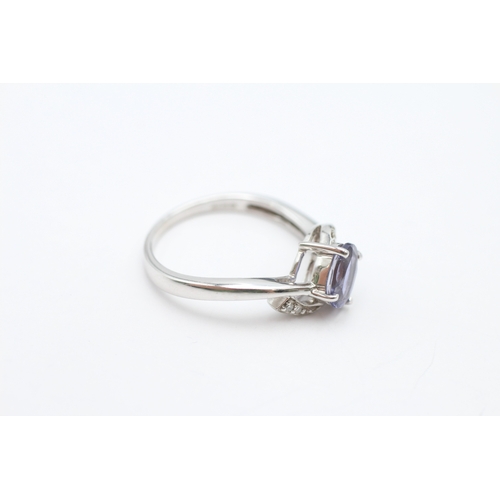184 - 9ct white gold tanzanite and diamond crossover ring (2.4g) Size N