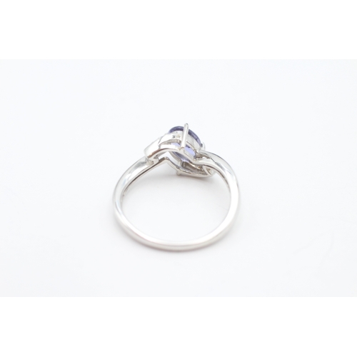 184 - 9ct white gold tanzanite and diamond crossover ring (2.4g) Size N