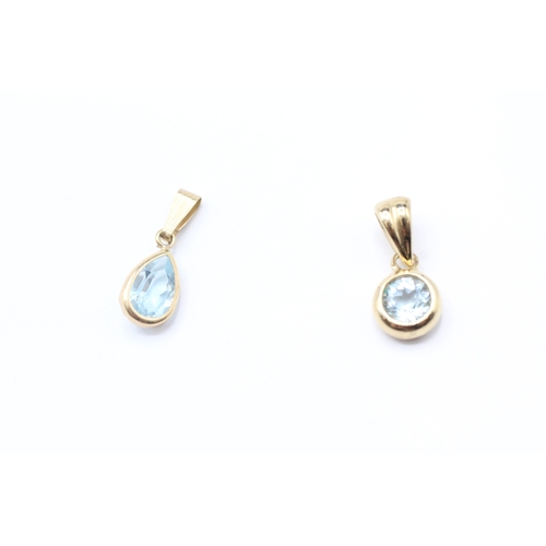 188 - 2 x 9ct gold topaz pendants (1.5g)