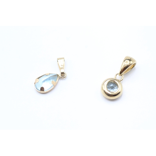 188 - 2 x 9ct gold topaz pendants (1.5g)