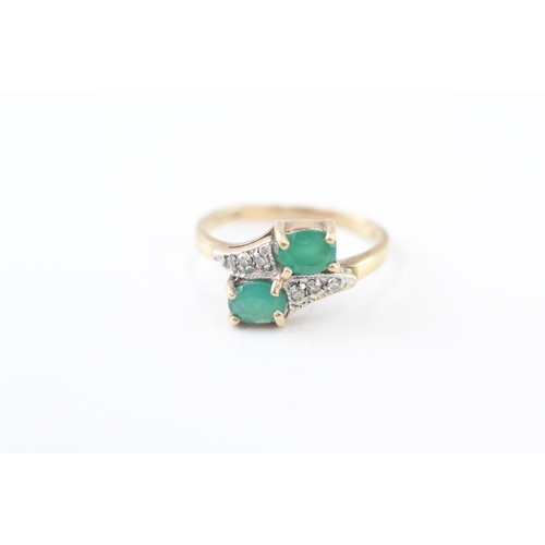 215 - 9ct gold emerald and diamond twin stone bypass ring (2.4g) Size J