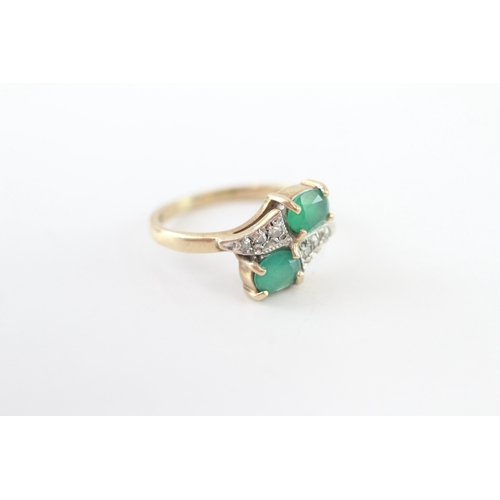 215 - 9ct gold emerald and diamond twin stone bypass ring (2.4g) Size J