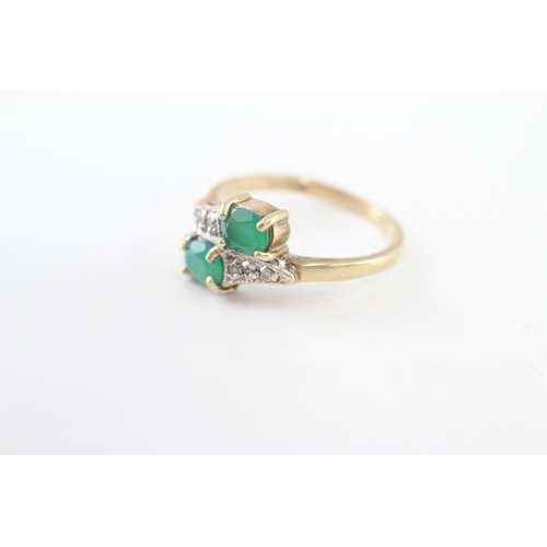 215 - 9ct gold emerald and diamond twin stone bypass ring (2.4g) Size J