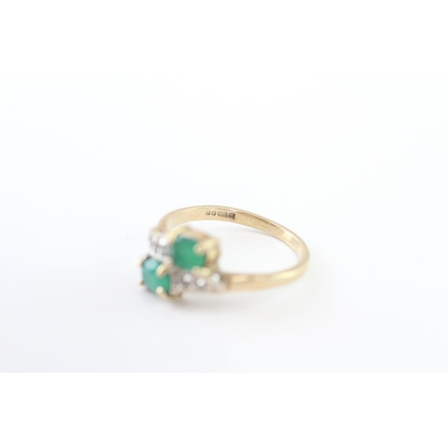 215 - 9ct gold emerald and diamond twin stone bypass ring (2.4g) Size J