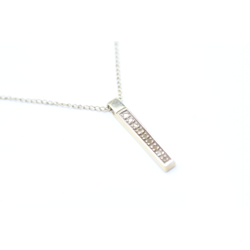 221 - 9ct gold diamond bar pendant on chain (2.2g)