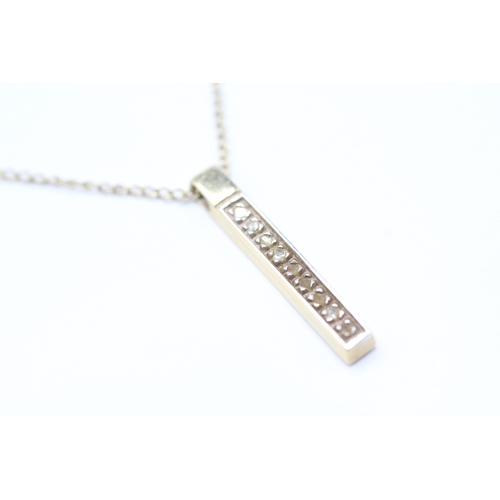 221 - 9ct gold diamond bar pendant on chain (2.2g)