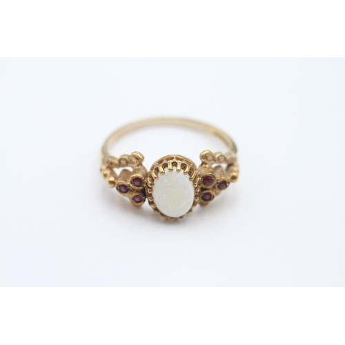 53 - 9ct gold opal and ruby dress ring (2.7g) Size P