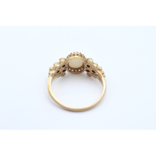 53 - 9ct gold opal and ruby dress ring (2.7g) Size P