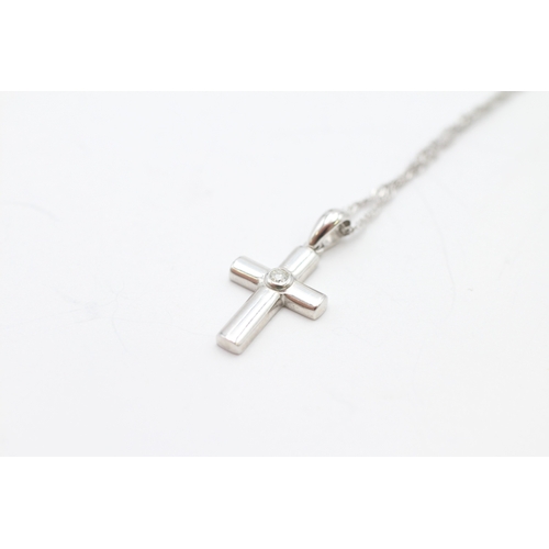 22 - 9ct white gold diamond cross pendant on chain (1.4g)