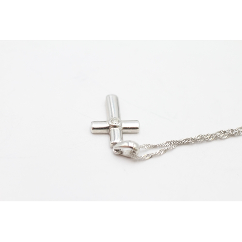 22 - 9ct white gold diamond cross pendant on chain (1.4g)