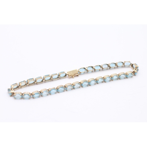 6 - 9ct gold blue topaz tennis bracelet (7.6g)