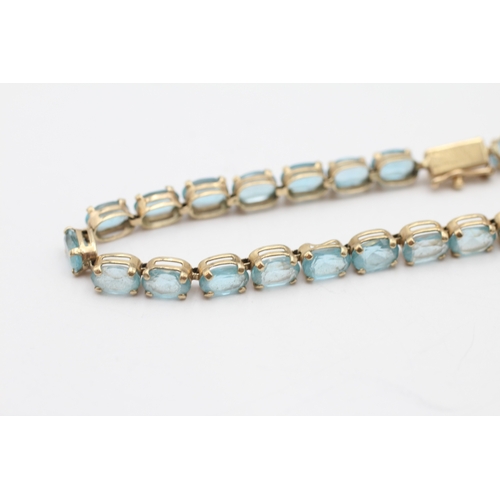 6 - 9ct gold blue topaz tennis bracelet (7.6g)