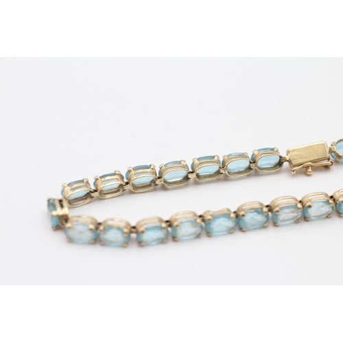 6 - 9ct gold blue topaz tennis bracelet (7.6g)
