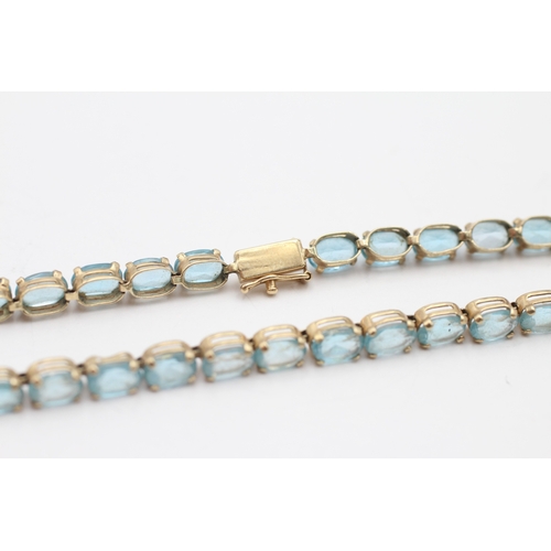 6 - 9ct gold blue topaz tennis bracelet (7.6g)