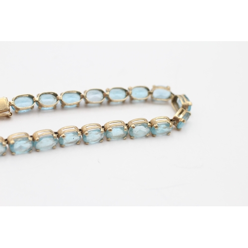 6 - 9ct gold blue topaz tennis bracelet (7.6g)