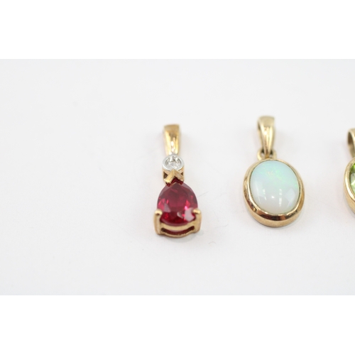 32 - 3 x 9ct gold synthetic ruby, diamond, peridot and opal pendants (2.3g)