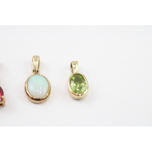 32 - 3 x 9ct gold synthetic ruby, diamond, peridot and opal pendants (2.3g)