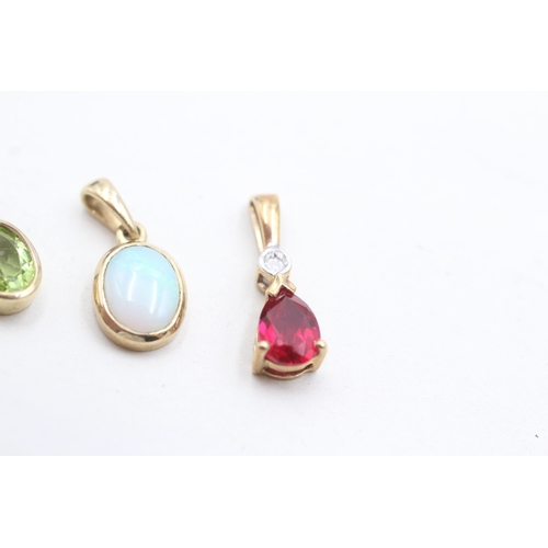32 - 3 x 9ct gold synthetic ruby, diamond, peridot and opal pendants (2.3g)