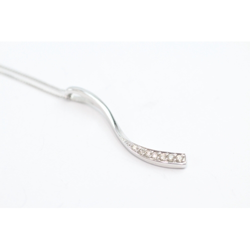 49 - 9ct white gold diamond set wave pendant necklace (1.6g)