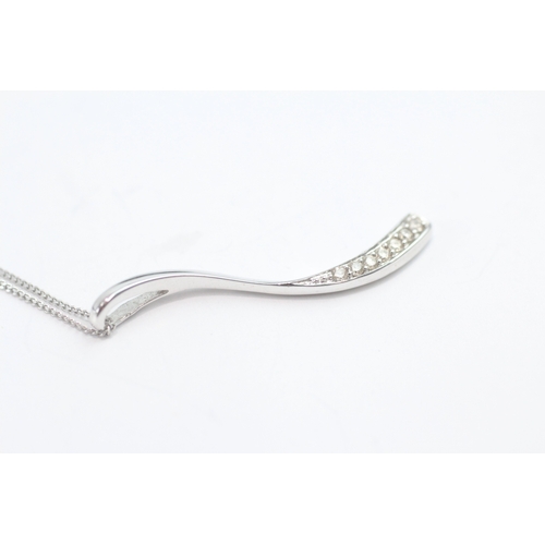 49 - 9ct white gold diamond set wave pendant necklace (1.6g)