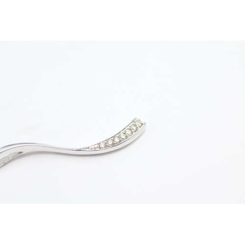 49 - 9ct white gold diamond set wave pendant necklace (1.6g)