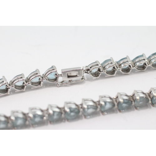 5 - 9ct white gold blue topaz tennis bracelet (13.9g)