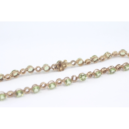 27 - 9ct gold peridot tennis bracelet (6.3g)