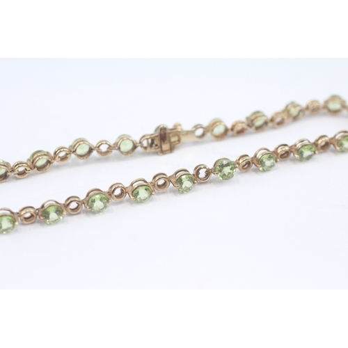 27 - 9ct gold peridot tennis bracelet (6.3g)