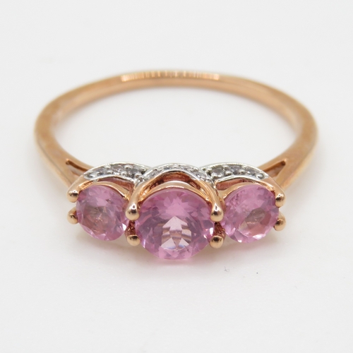 62 - 9ct gold diamond and pink sapphire trilogy ring (2.1g) Size Q