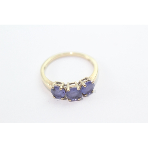 46 - 9ct gold tanzanite three-stone ring (1.9g) Size L 1/2