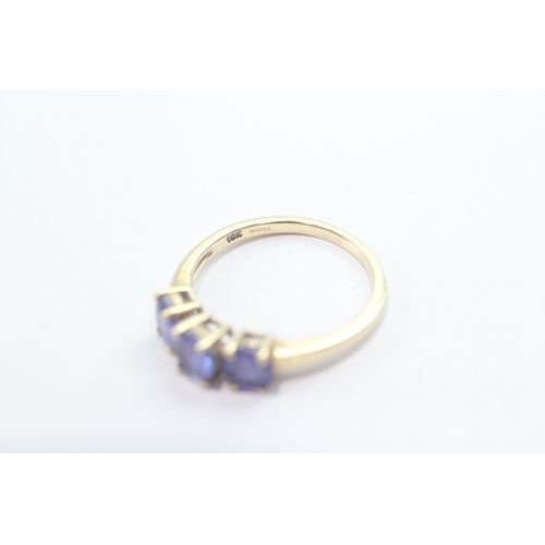 46 - 9ct gold tanzanite three-stone ring (1.9g) Size L 1/2