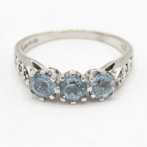174 - 9ct white gold topaz three stone ring with diamond shoulders (2.8g) size O 1/2
