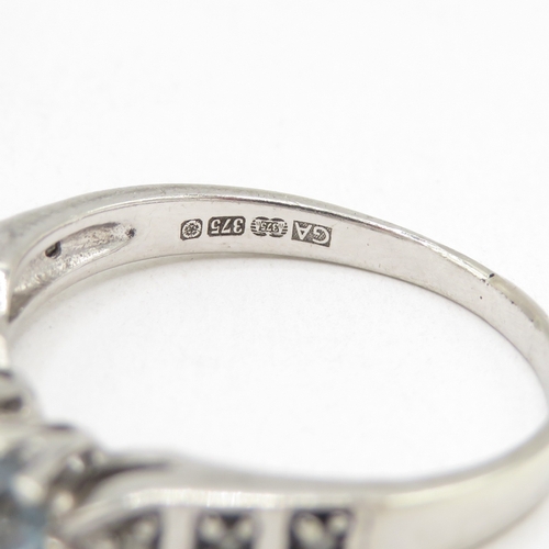 174 - 9ct white gold topaz three stone ring with diamond shoulders (2.8g) size O 1/2