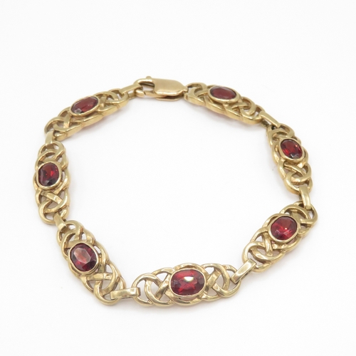279 - 9ct gold garnet set Celtic link bracelet (13.6g)