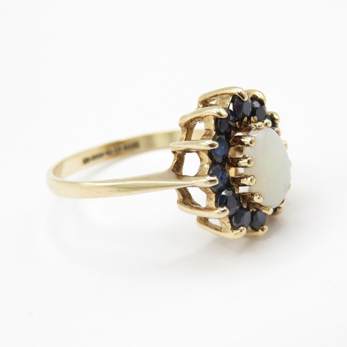 290 - 9ct gold opal and sapphire halo ring (2.7g) size N