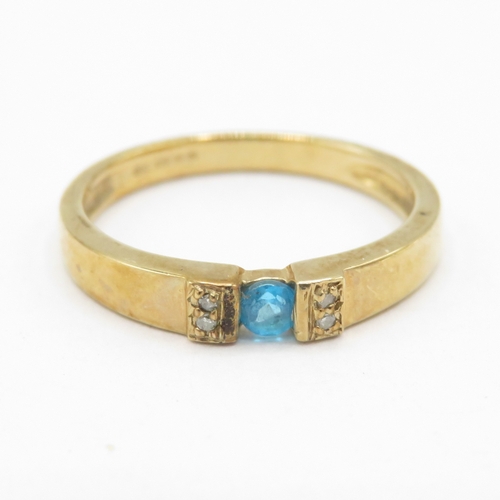 295 - 9ct gold blue gemstone tension set ring with diamond shoulders (1.8g) size J