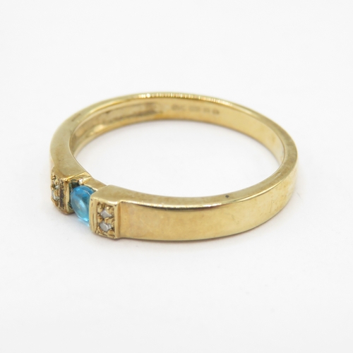 295 - 9ct gold blue gemstone tension set ring with diamond shoulders (1.8g) size J