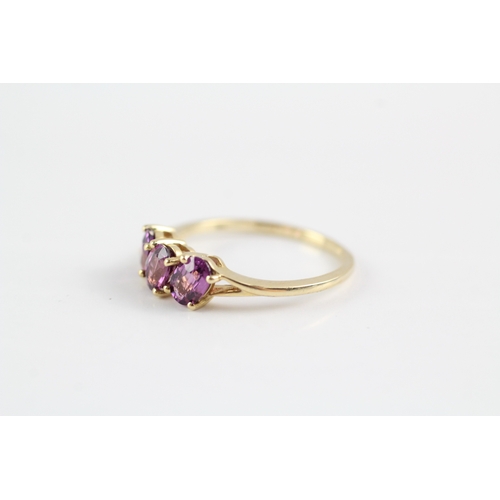 227 - 9ct gold garnet three stone ring (2.1g) Size P 1/2