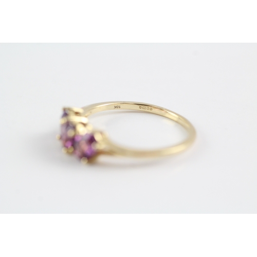 227 - 9ct gold garnet three stone ring (2.1g) Size P 1/2