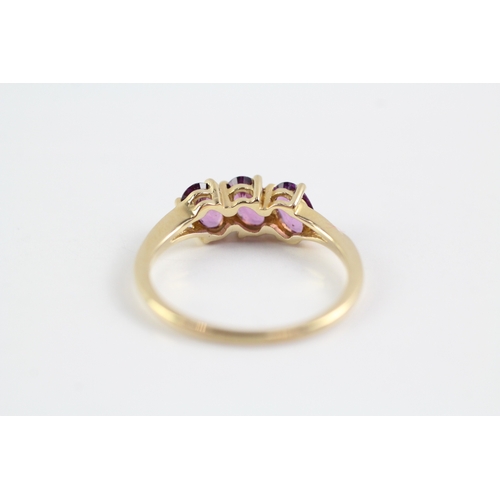 227 - 9ct gold garnet three stone ring (2.1g) Size P 1/2