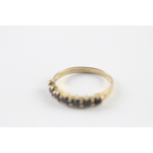 57 - 9ct gold sapphire half eternity ring (1.4g) Size N